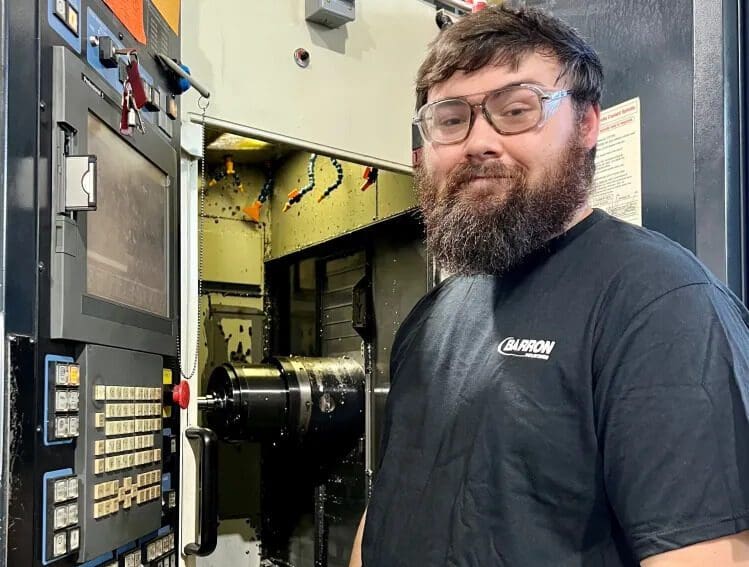 yan Walther, an apprentice at Oxford-based Barron Industries, adjusts machine settings. Courtesy, Barron Industries