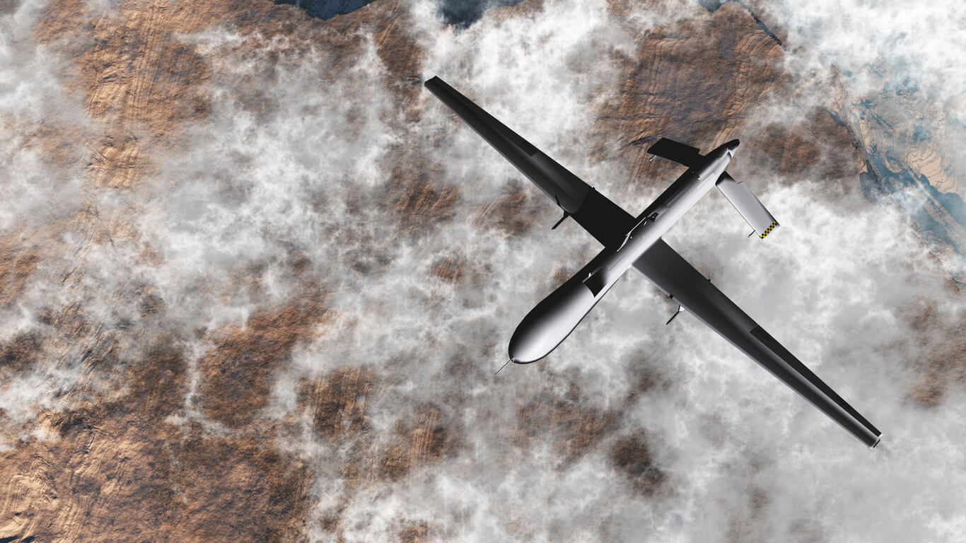 General Atomics MQ-1 Predator drone flying over the clouds.